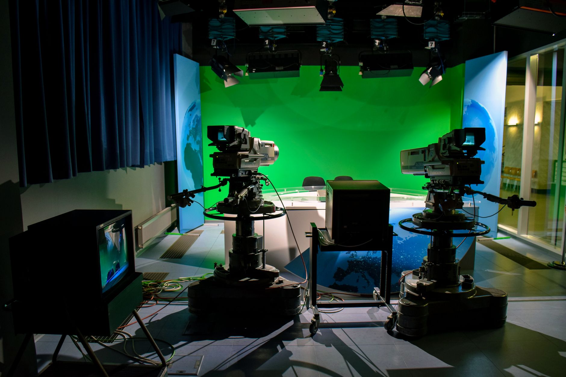 Behind-the-scenes view of a television production set with lighting equipment