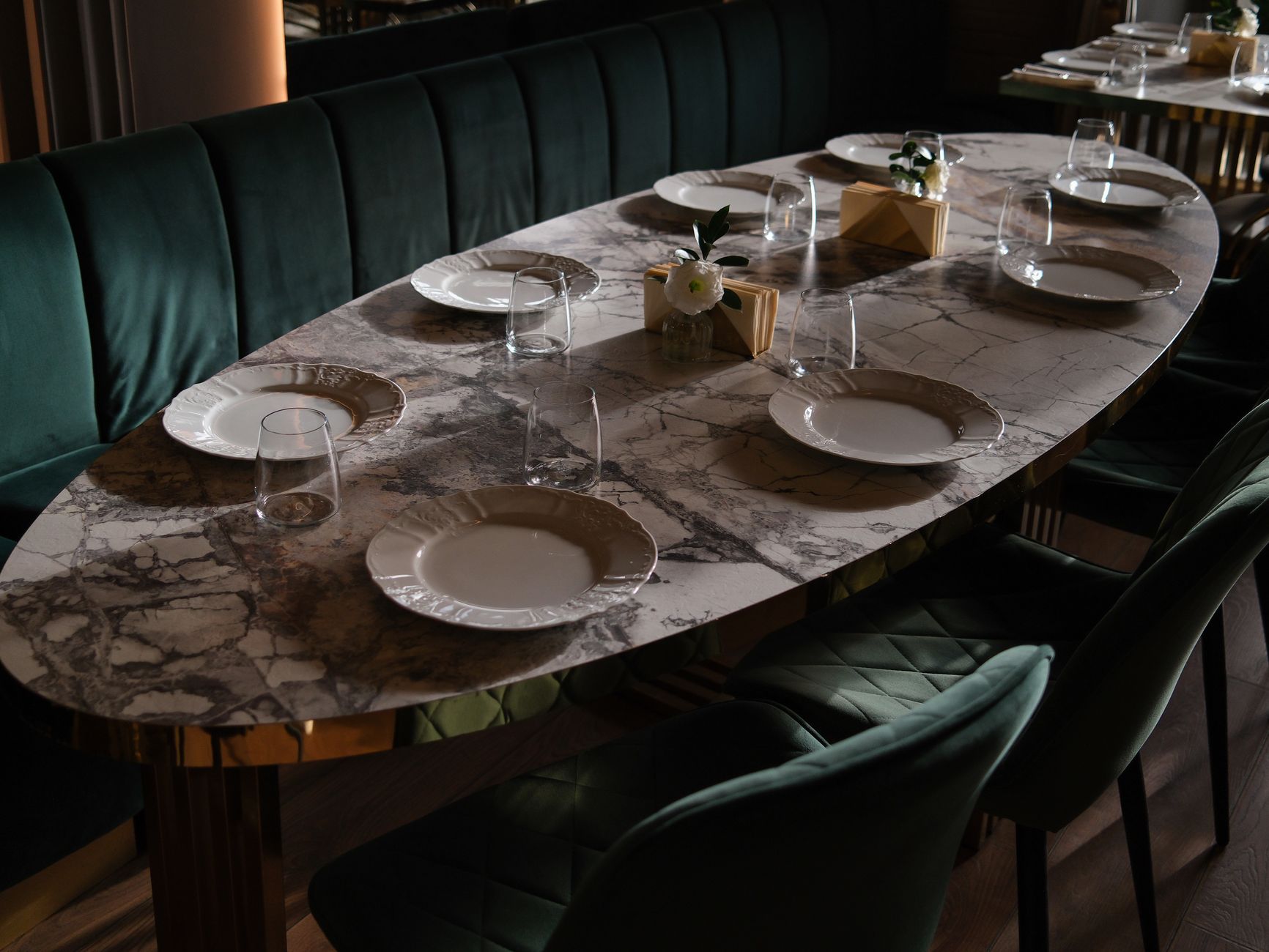Warm and elegant restaurant interior with attentive table settings and ambient lighting