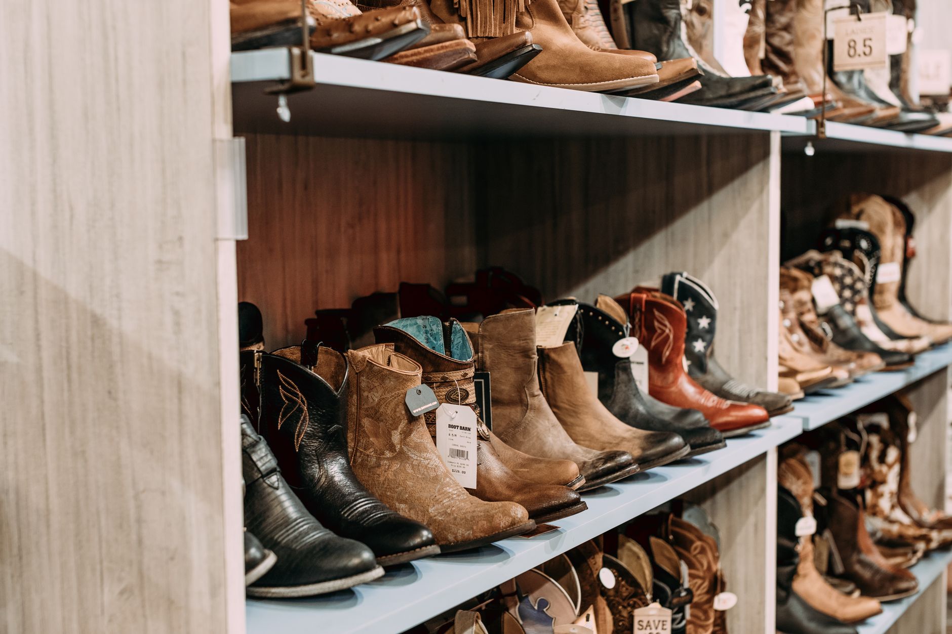Row of western and work boots displayed on a retail shelf