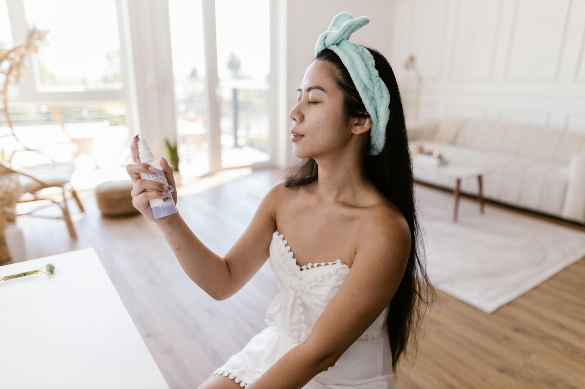 Floral hair and body mist spray bottle on a bathroom shelf