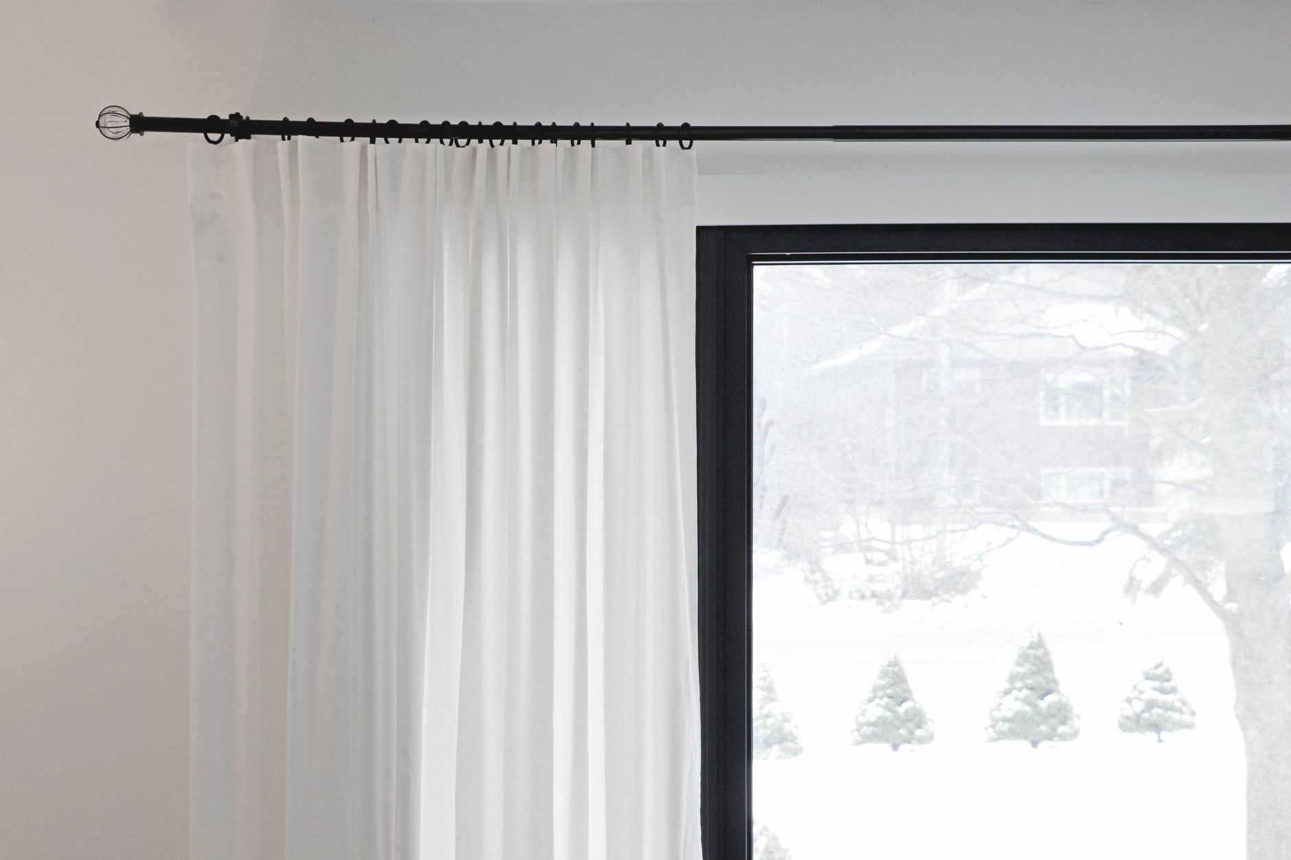 Blackout curtain panels hanging in a bright modern living room