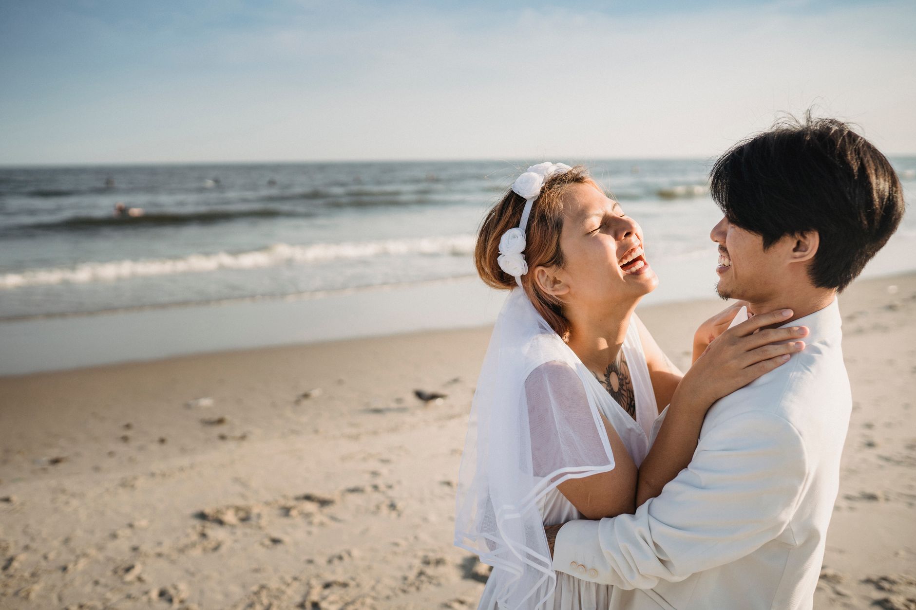 Guests in lightweight dresses at a casual beach wedding ceremony