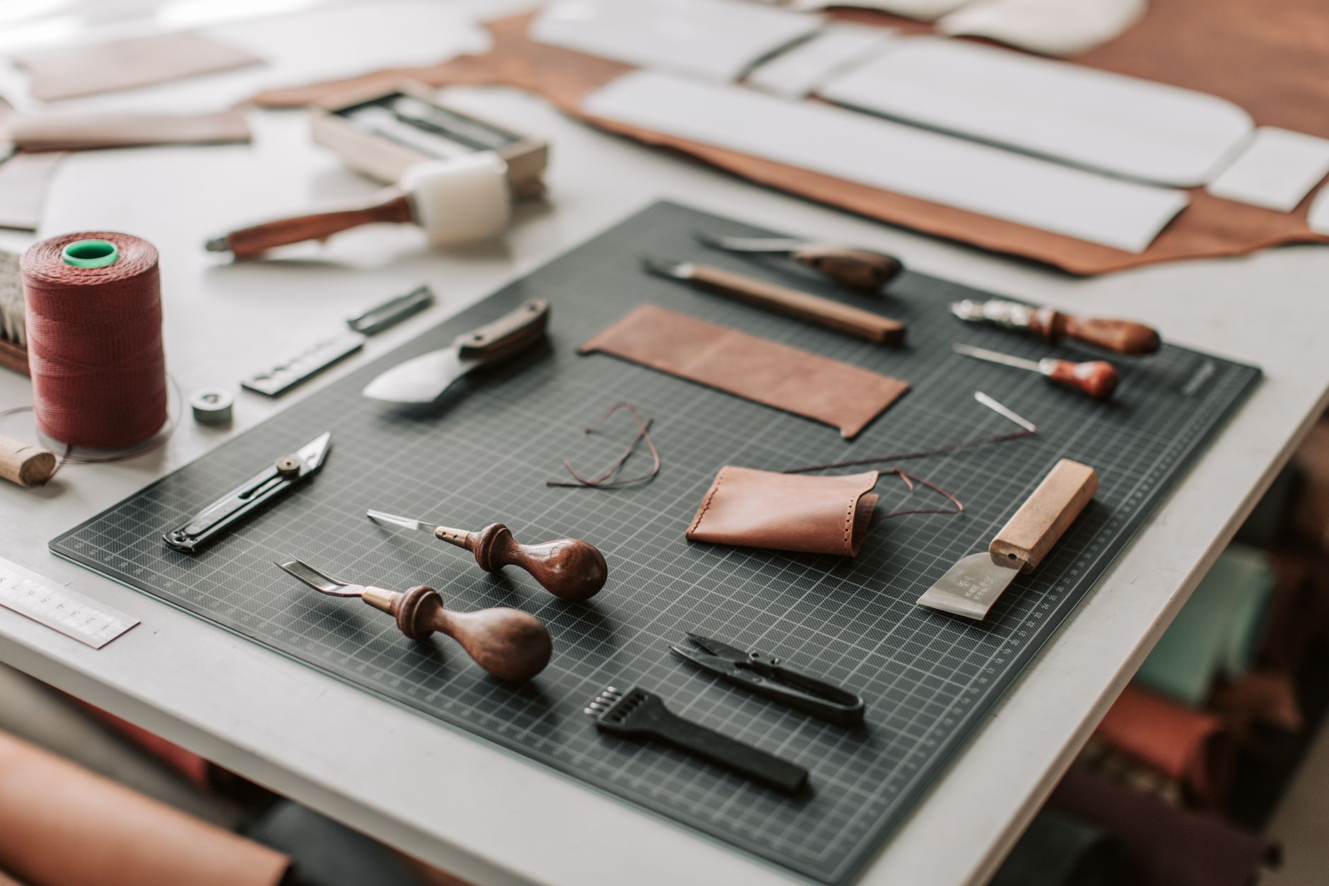 Artisan hands working on Italian leather goods, representing the material craft tradition behind Tod's collections