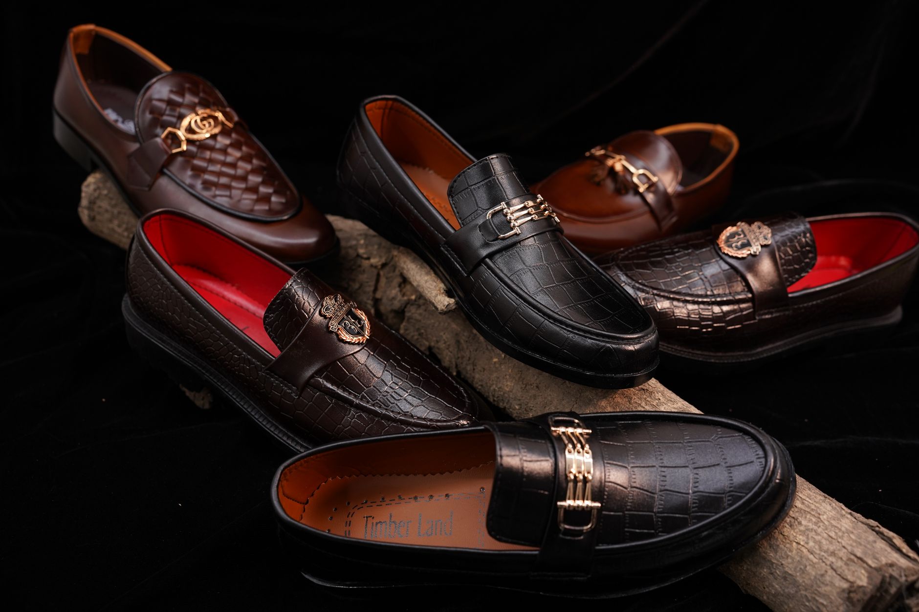 Array of designer men's shoes displayed on a white surface