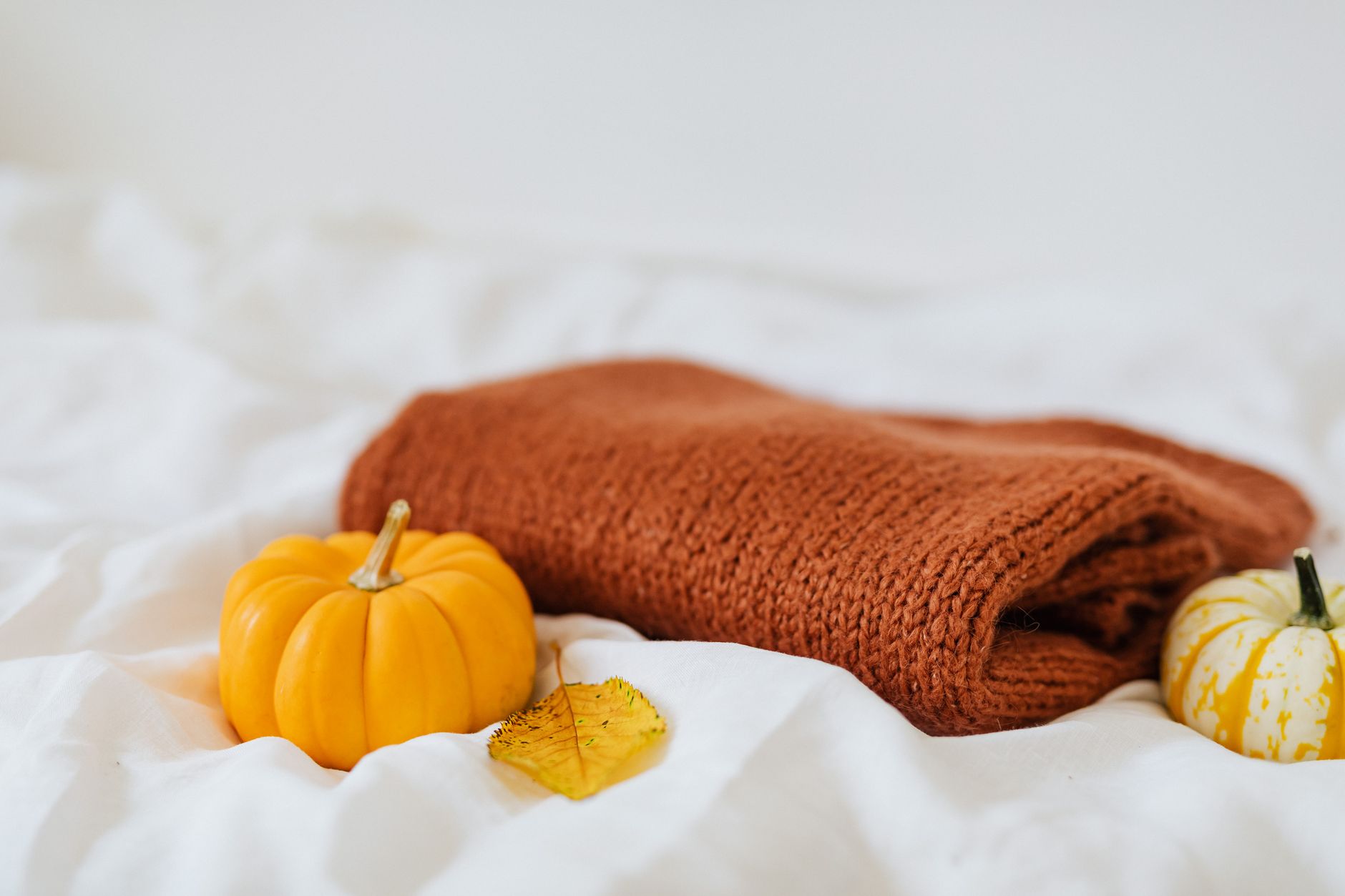 Neatly folded cashmere sweaters displayed on a wooden surface