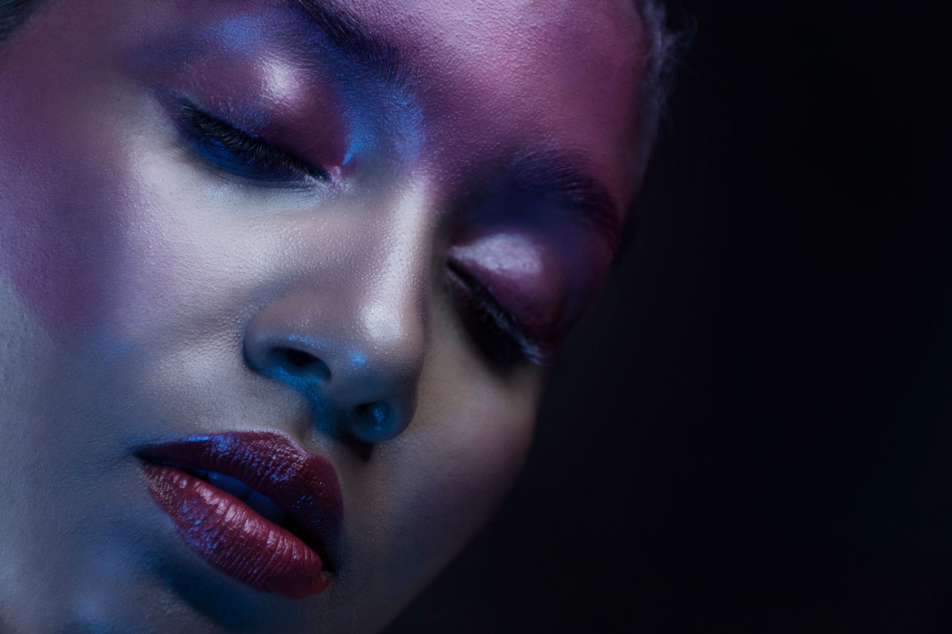 High-fashion editorial portrait of a young woman with dramatic beauty look