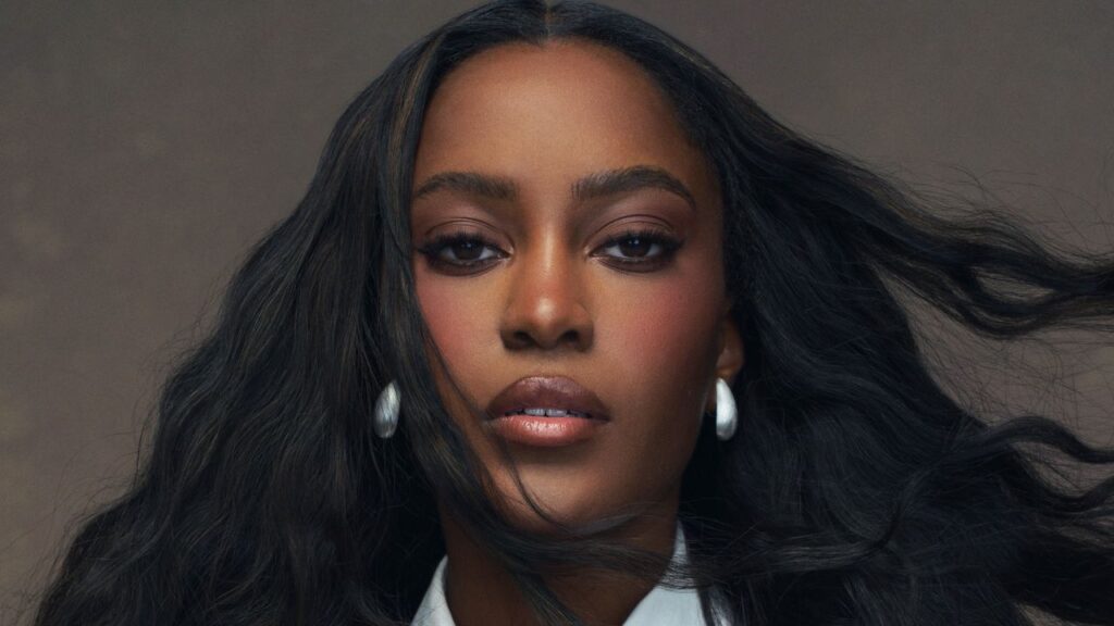 Woman with polished makeup and styled hair ready for a television appearance