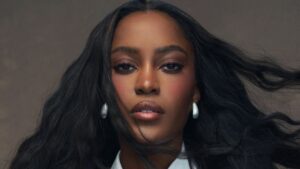 Woman with polished makeup and styled hair ready for a television appearance
