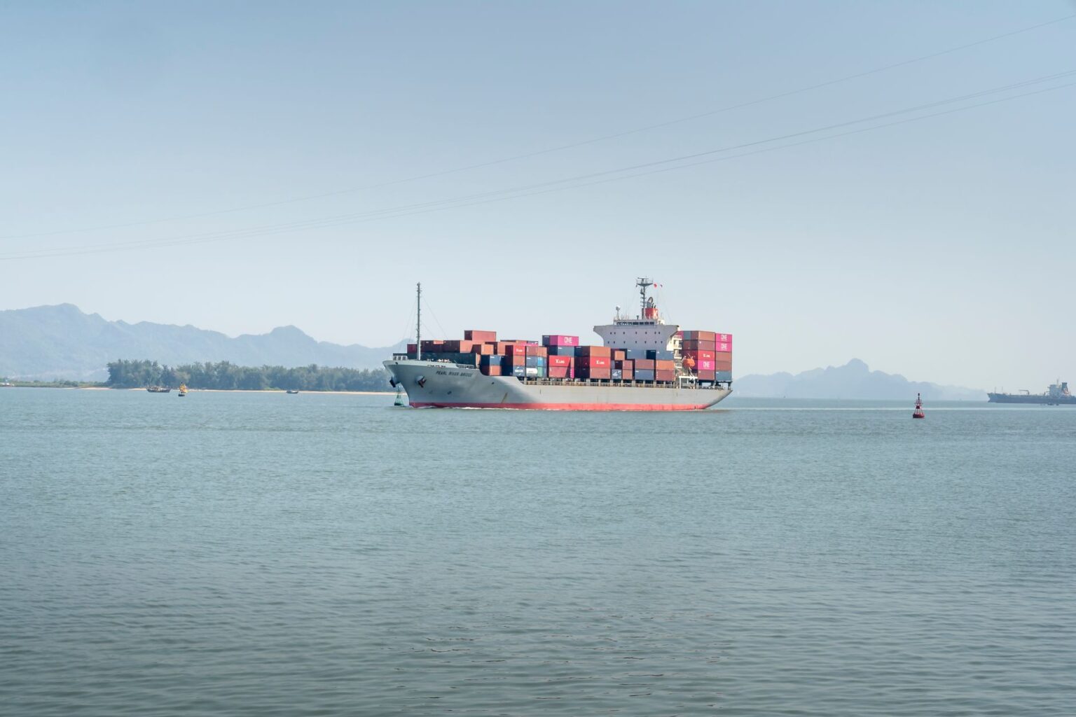 Large container ship at port carrying retail freight across ocean trade lanes