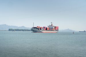 Large container ship at port carrying retail freight across ocean trade lanes