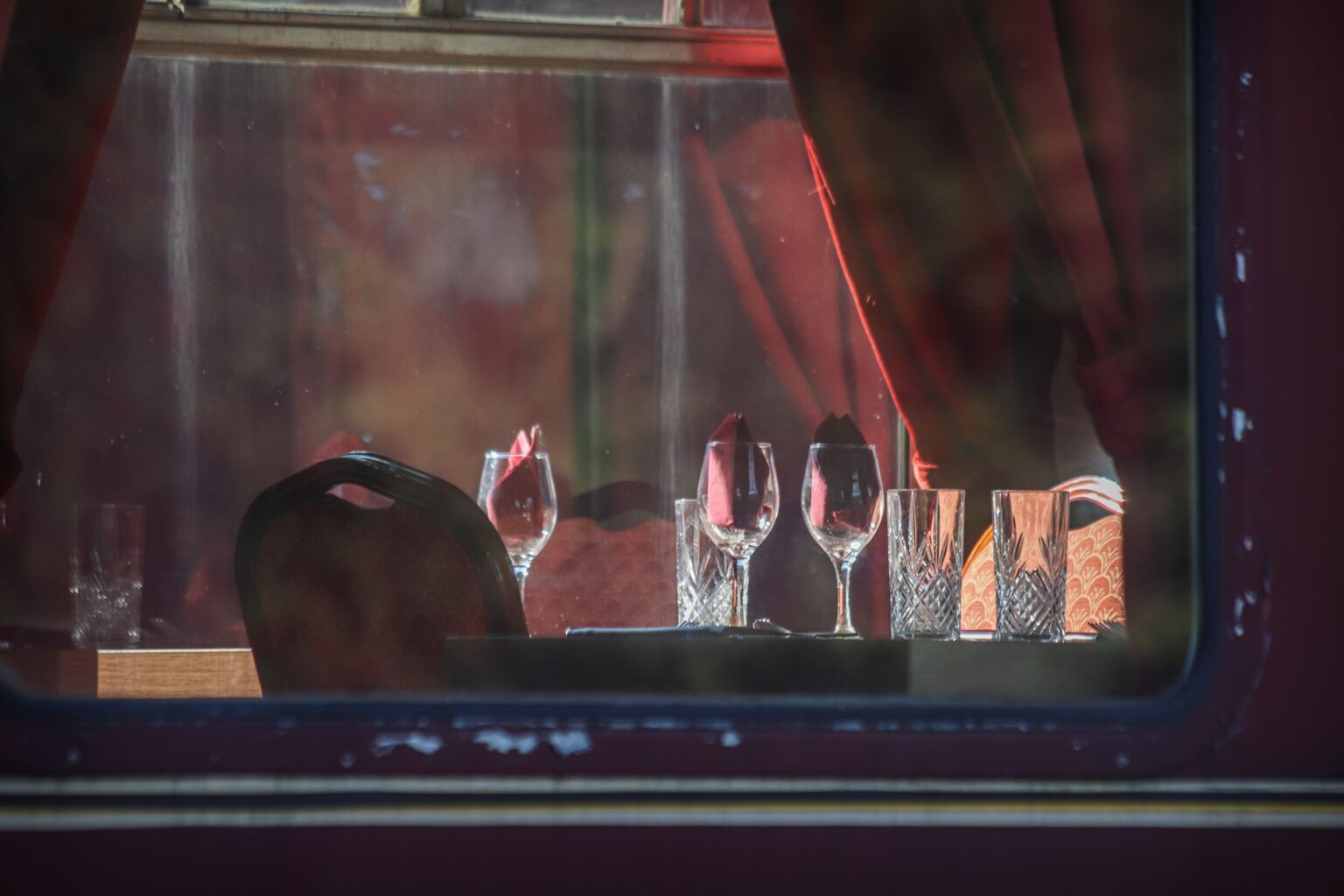 Elegant passengers aboard a luxury train, evoking the Carolina Herrera Net-a-Porter capsule launch event setting