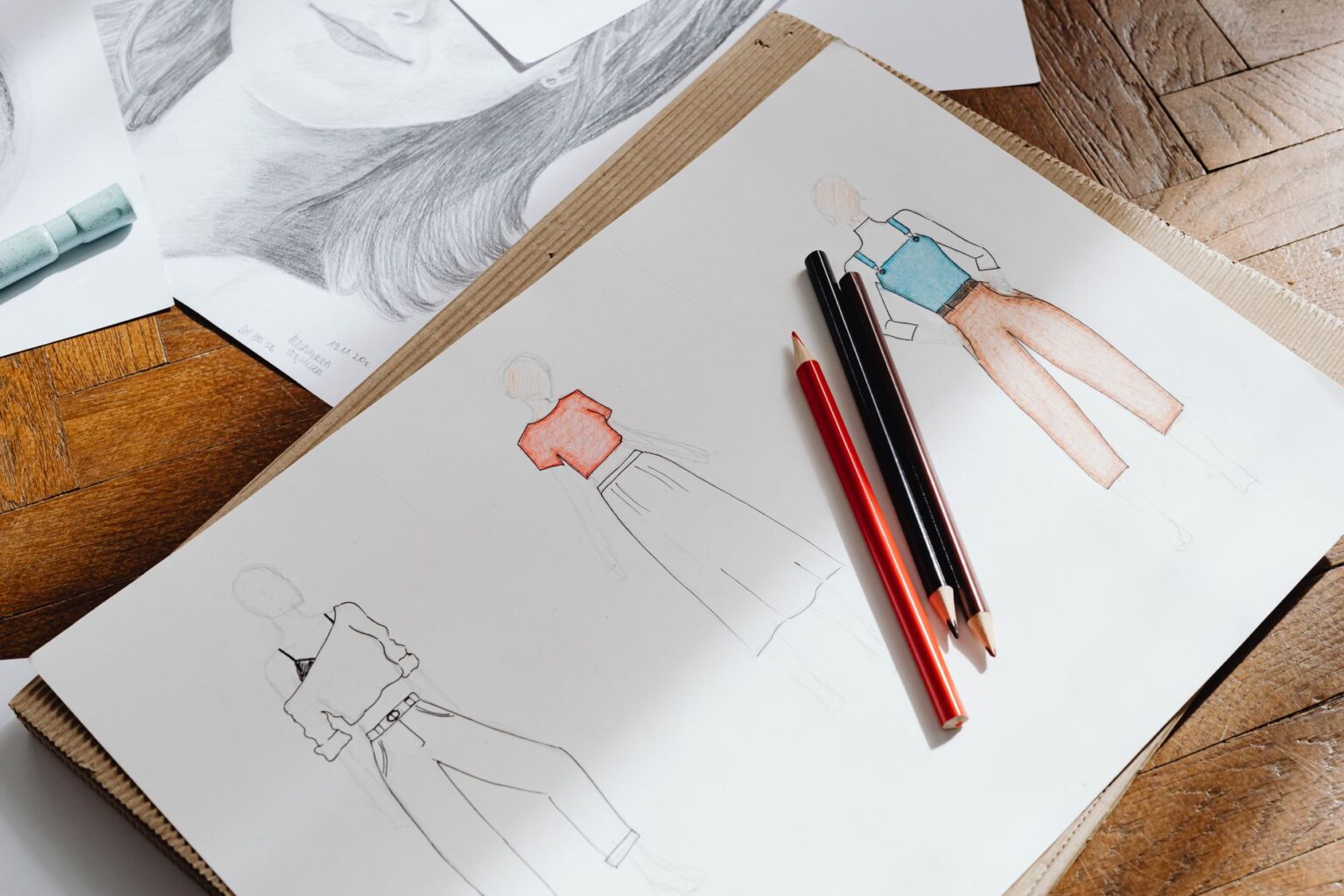 Close-up of fashion design sketches on paper showing garment silhouettes