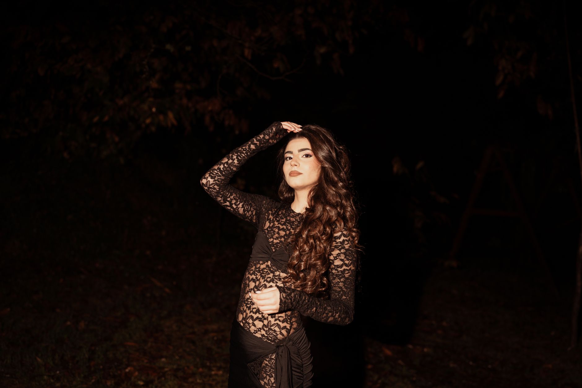 A black lace formal dress on display, referencing Oscar de la Renta style elegance