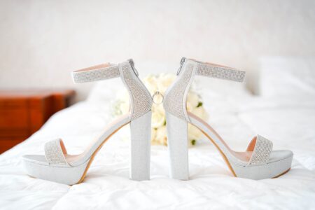 Custom white bridal heels displayed on a clean surface for a formal wedding ceremony