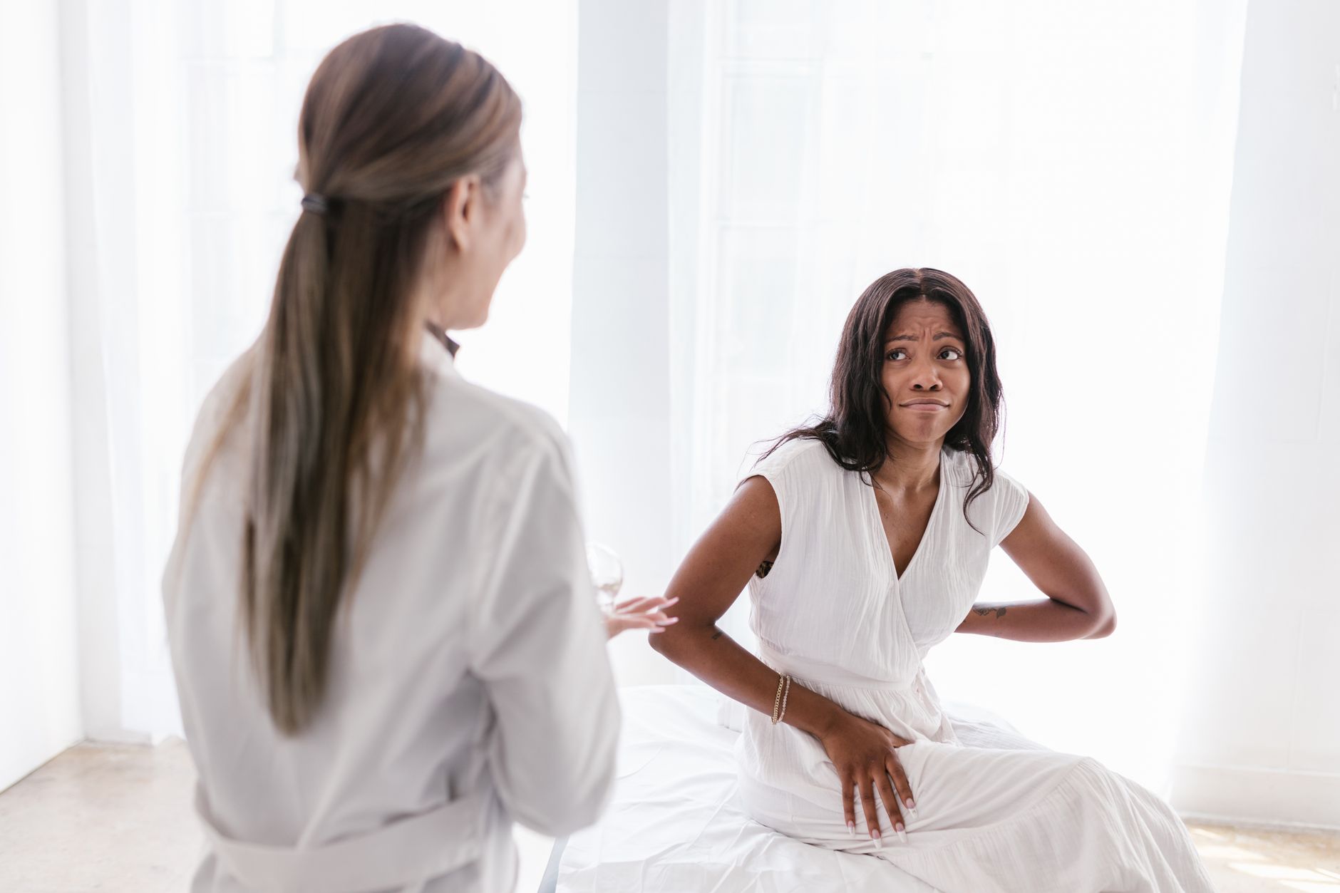 Esthetician reviewing a client's skin during a professional acne consultation