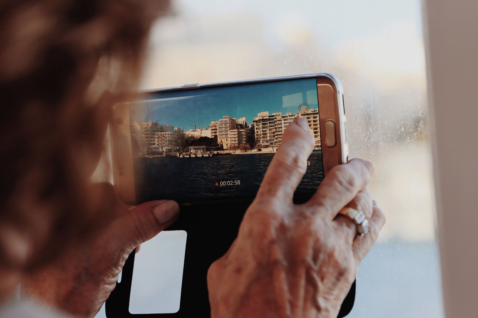 Woman's manicured hands photographed against an urban skyline backdrop