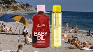 Bottles of sunscreen oil and SPF products arranged on a sandy beach surface