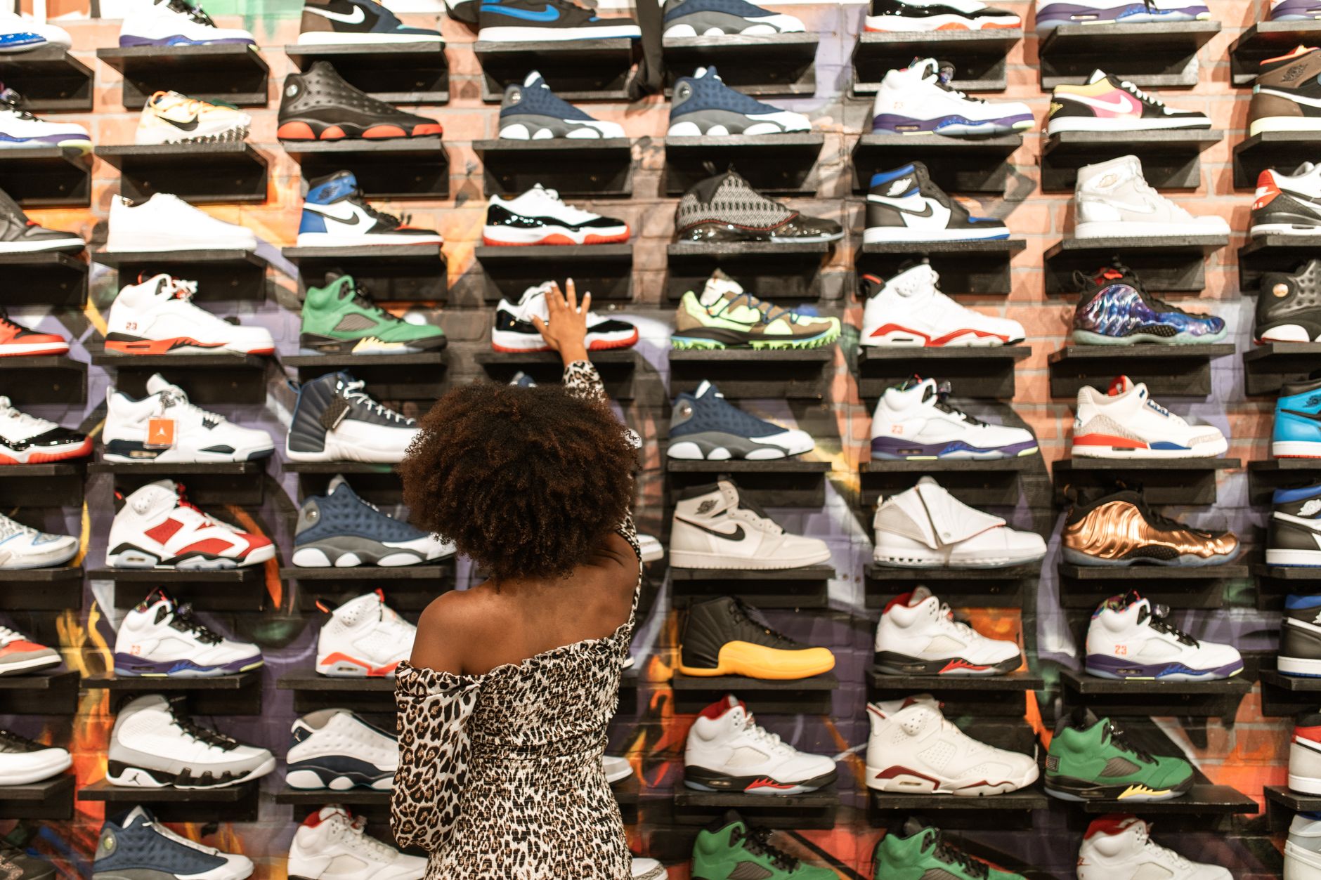 Person browsing sneakers online on a laptop for resale purchase