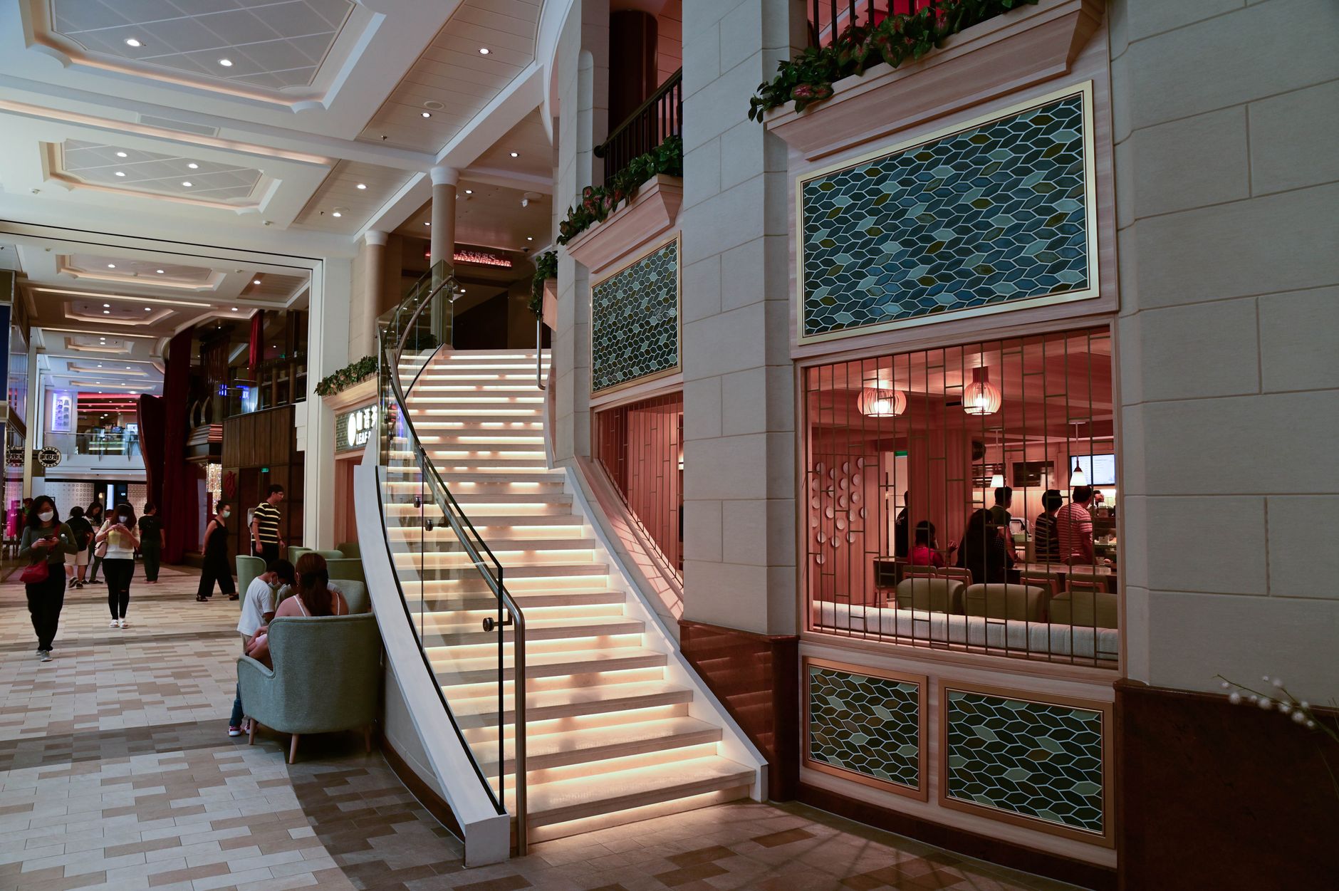 Modern upscale shopping mall interior with open atrium and luxury brand storefronts