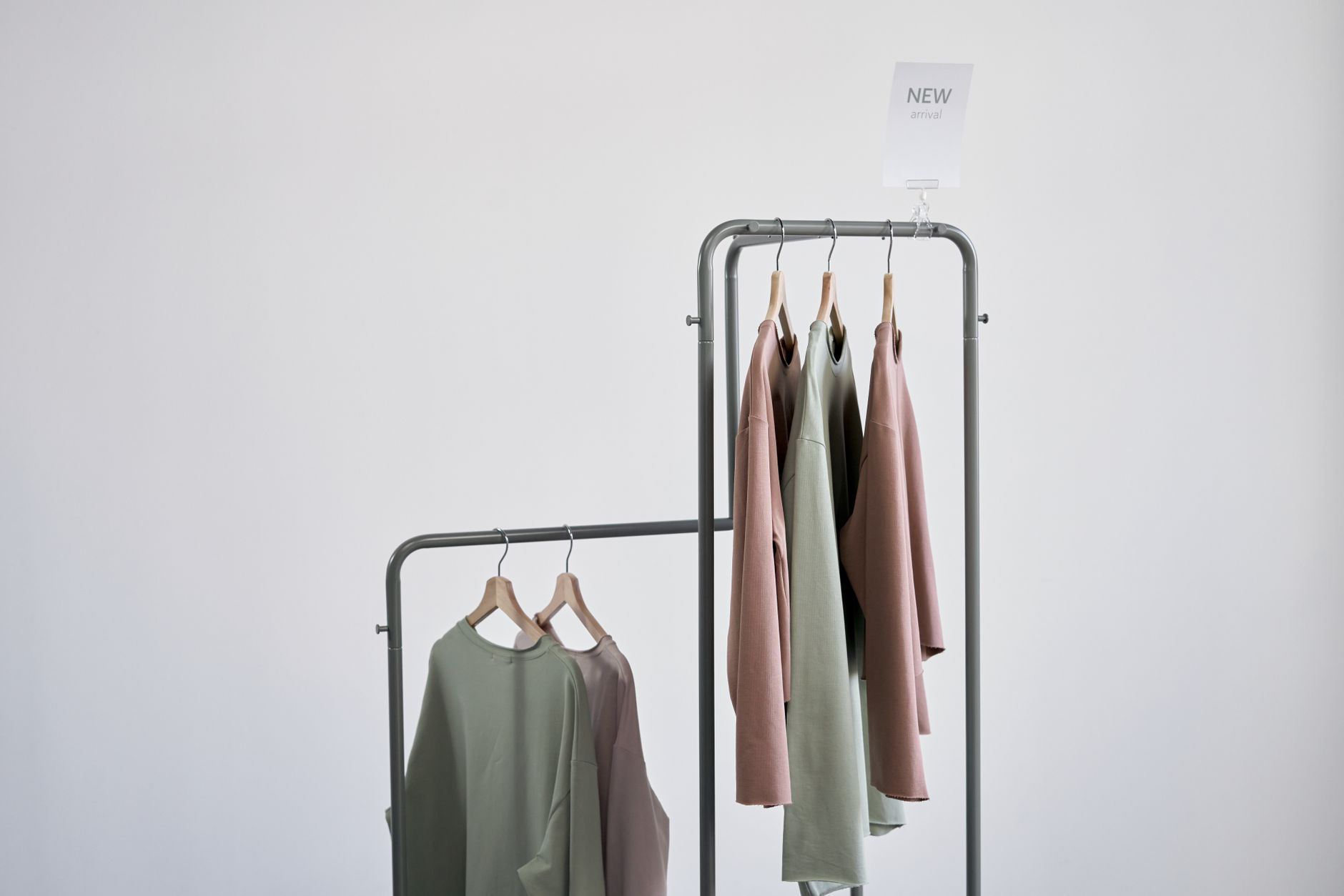 Designer garments arranged on a clothing rack in a retail studio