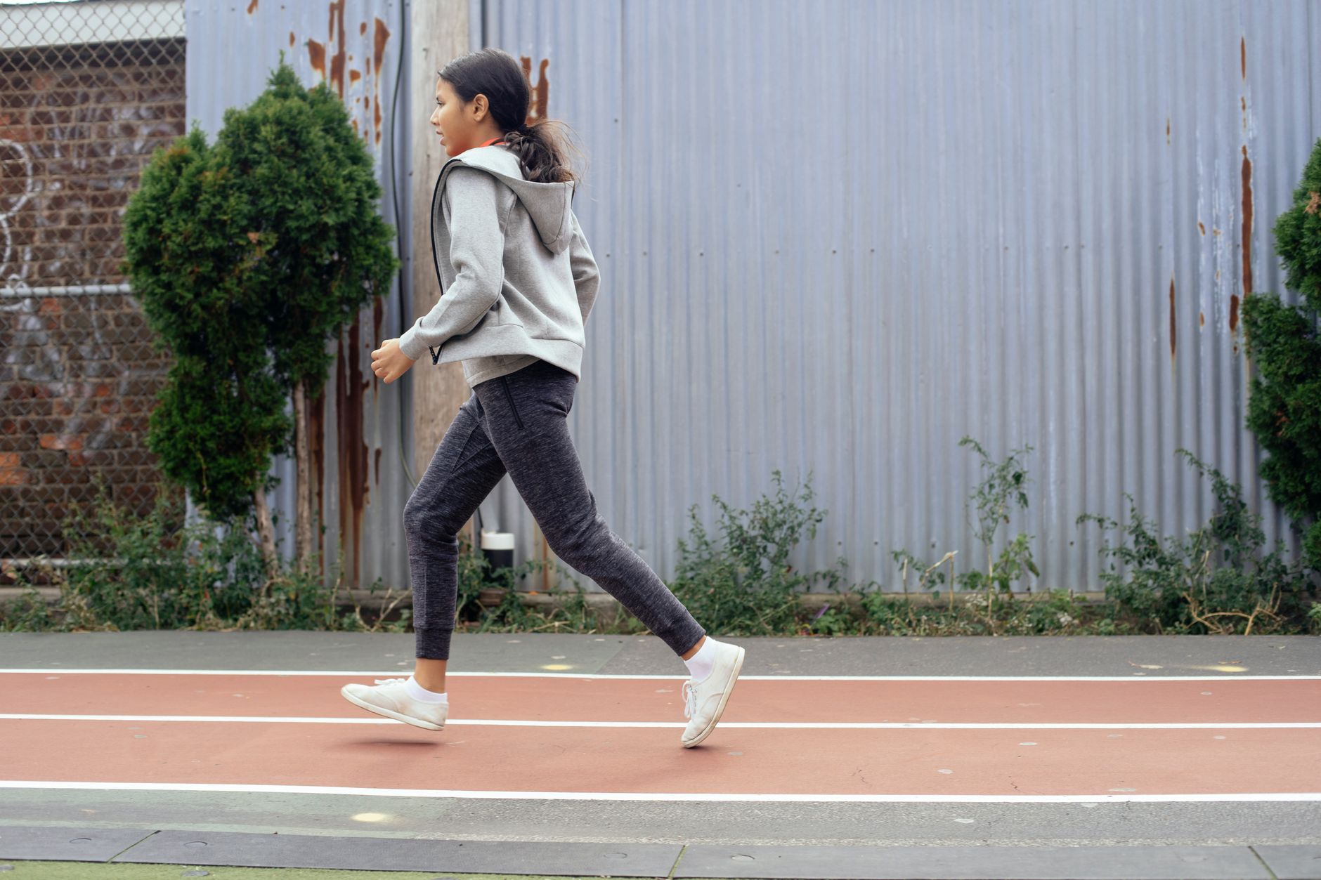 Casual runner in athletic shoes on a city path