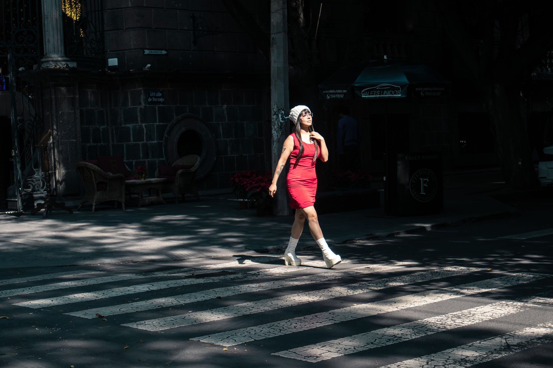Woman walking in heeled shoes on a city street