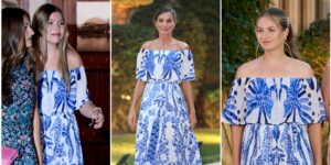 A blue and white printed summer dress hanging in a bright wardrobe