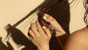 Close-up of a hairbrush with shed strands, representing hair loss concerns