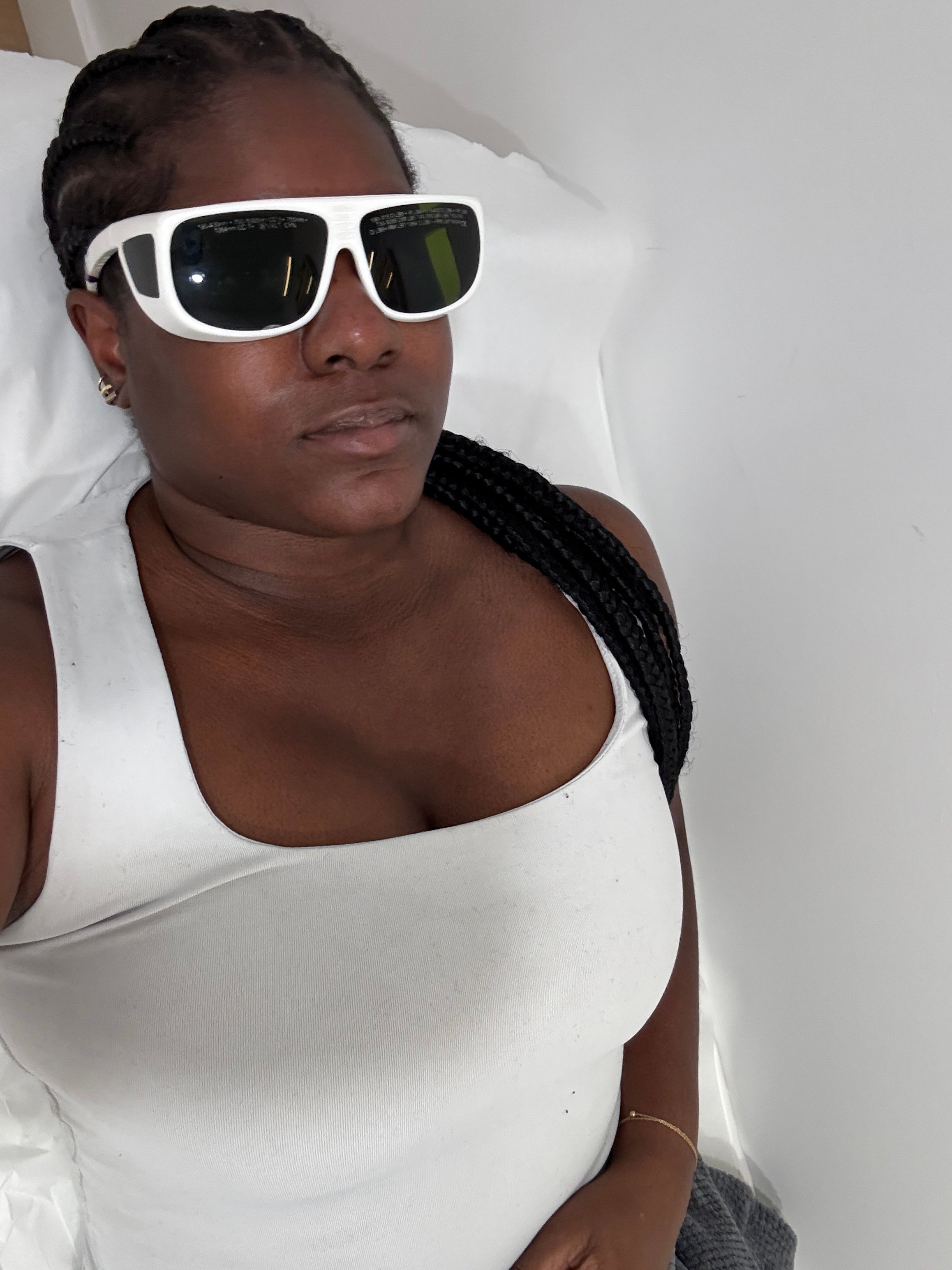 A person preparing for a laser skin treatment in a clinical setting
