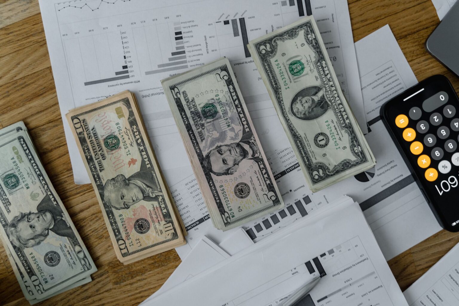 Executives gathered around a table reviewing financial reports during a quarterly earnings presentation