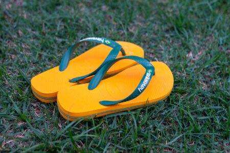 Bright rubber flip-flops laid flat on a white surface
