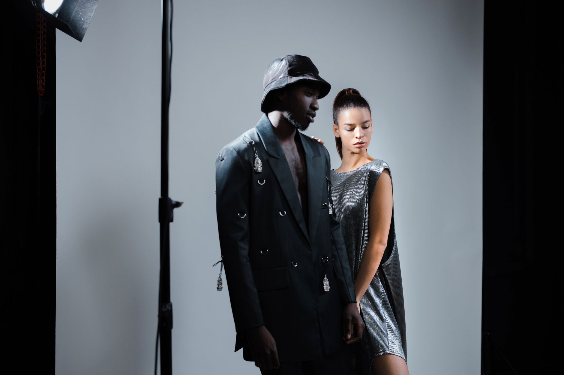 Models walking a fashion runway in sharp, structured clothing