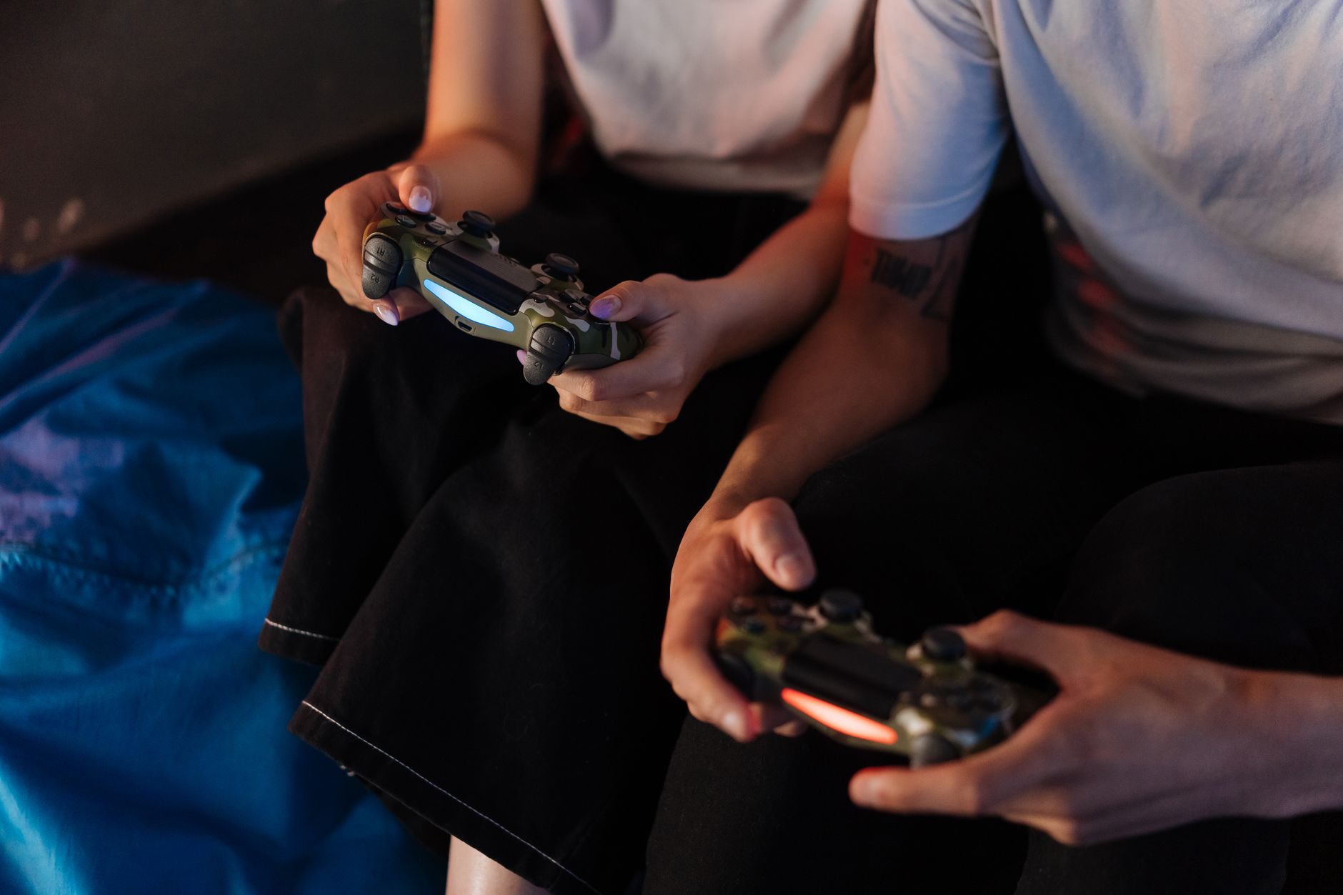 Person holding a gaming controller with sports game on screen