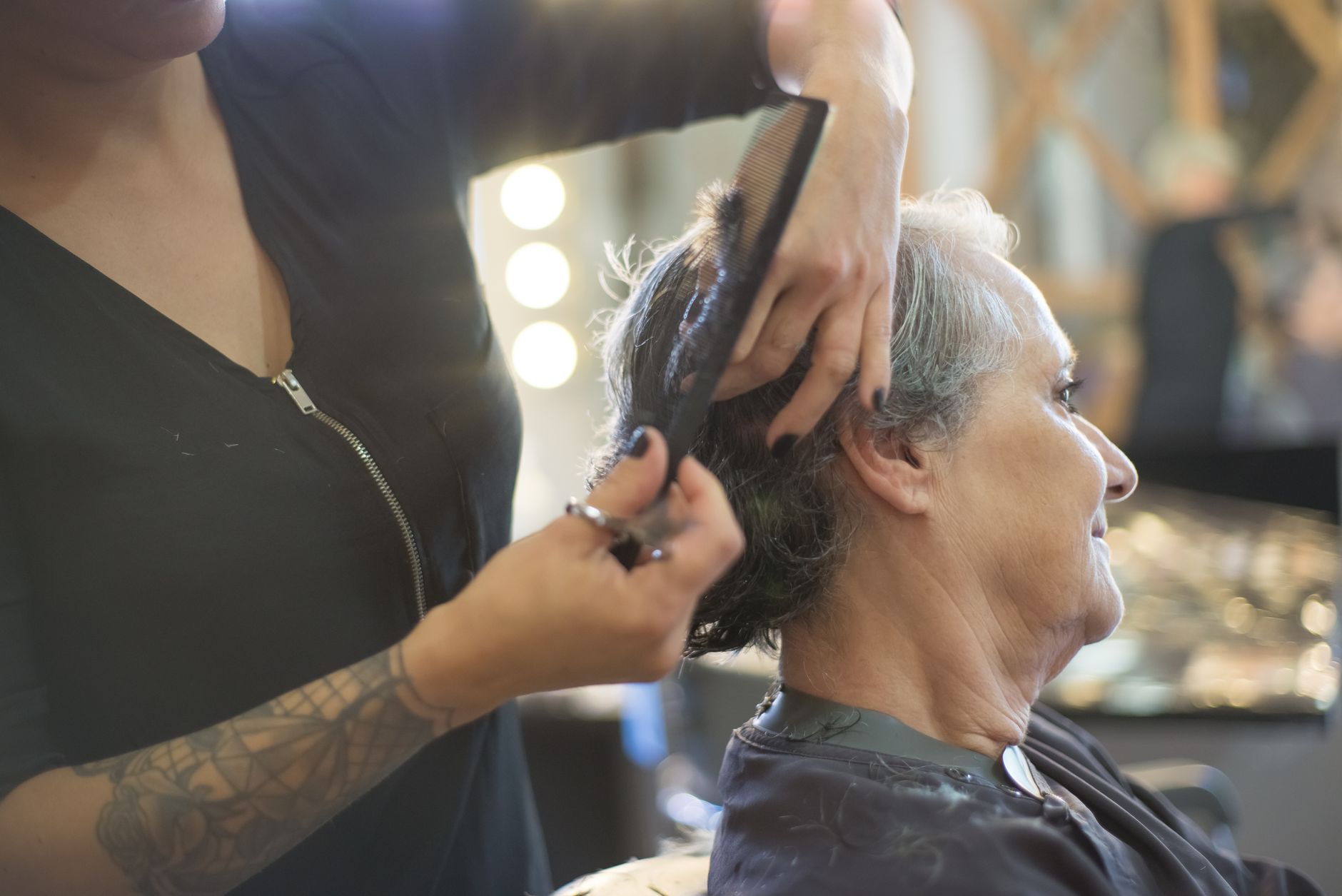 Woman getting a short bob haircut at a salon