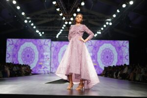 Ayo Edebiri Wears Chanel Haute Couture Bustle to BFI London Model walking a high fashion runway in structured couture gown