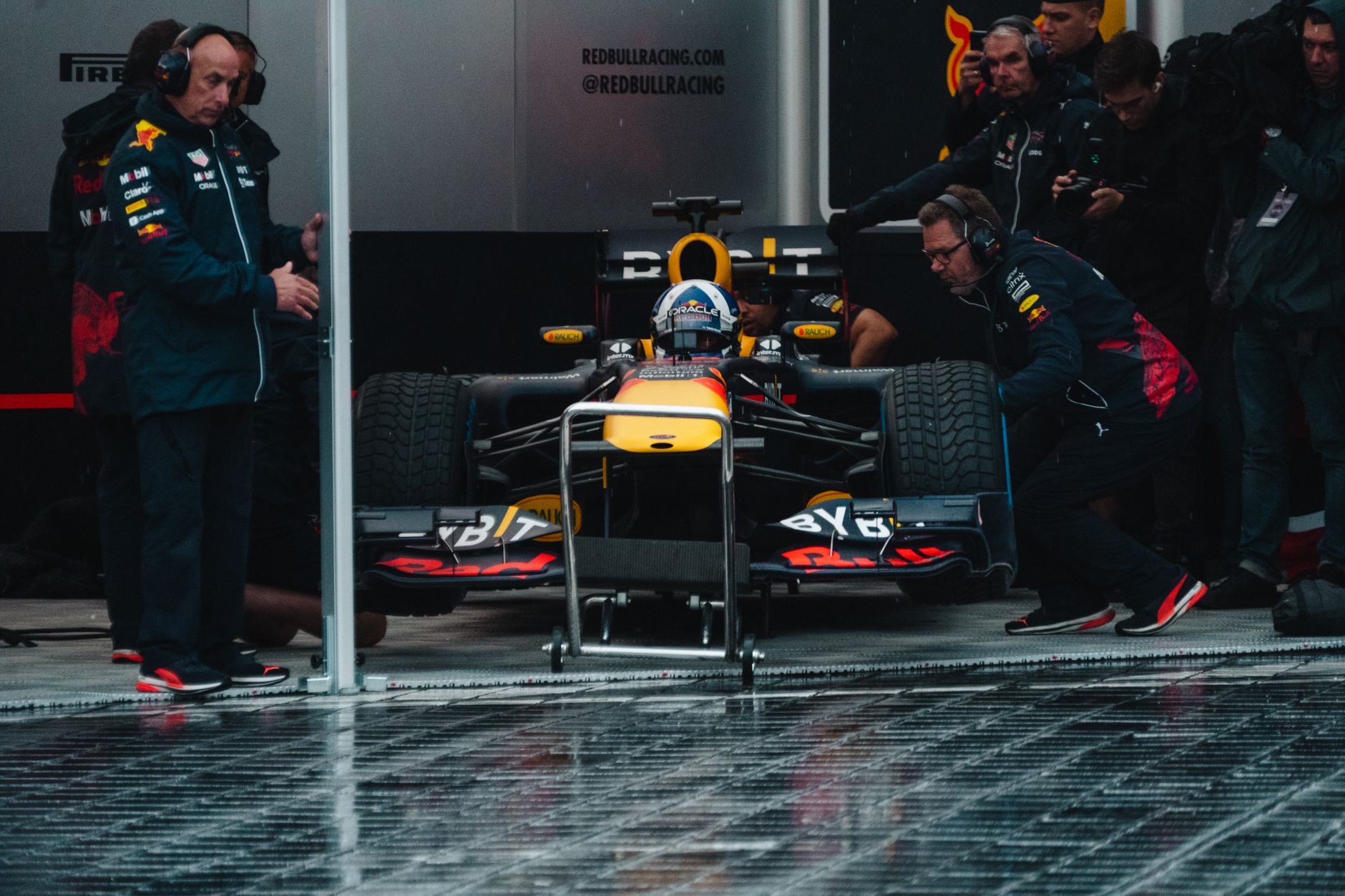 Bright floodlights illuminate a Formula 1 circuit at night during race weekend