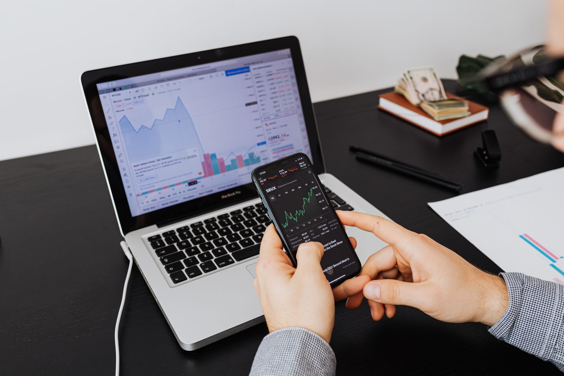 Person checking investment portfolio on smartphone at home
