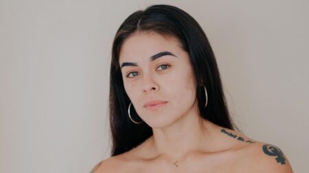 After a BRCA Mastectomy, She Chose Flat — and Went Public Woman looking directly at camera with a confident, open expression, representing body autonomy after mastectomy