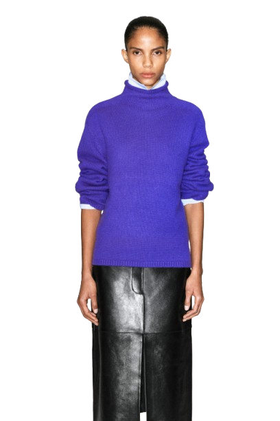 Woman in purple sweater styled with complementary fall outfit on city street